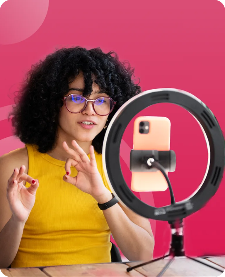 Creator recording a voiceover with a ring light and phone